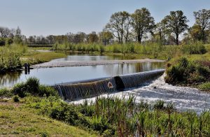 Low weir waterfall in a rural river